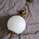 Golden metal and opaline glass globe