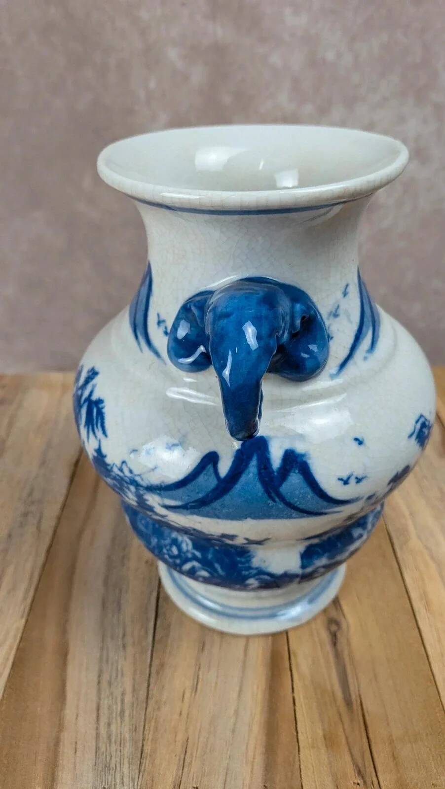 Blue and white Chinese vase with sculpted handles and landscape decoration.