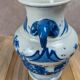 Blue and white Chinese vase with sculpted handles and landscape decoration.