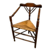 Antique corner chair with a straw seat, circa 1880–1910.