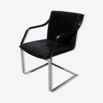 Chair with steel and leather armrests