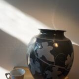 Black vase with plant decoration by Philippe Jacques