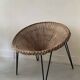 Italian basket chair in rattan and black metal, 1950s design.