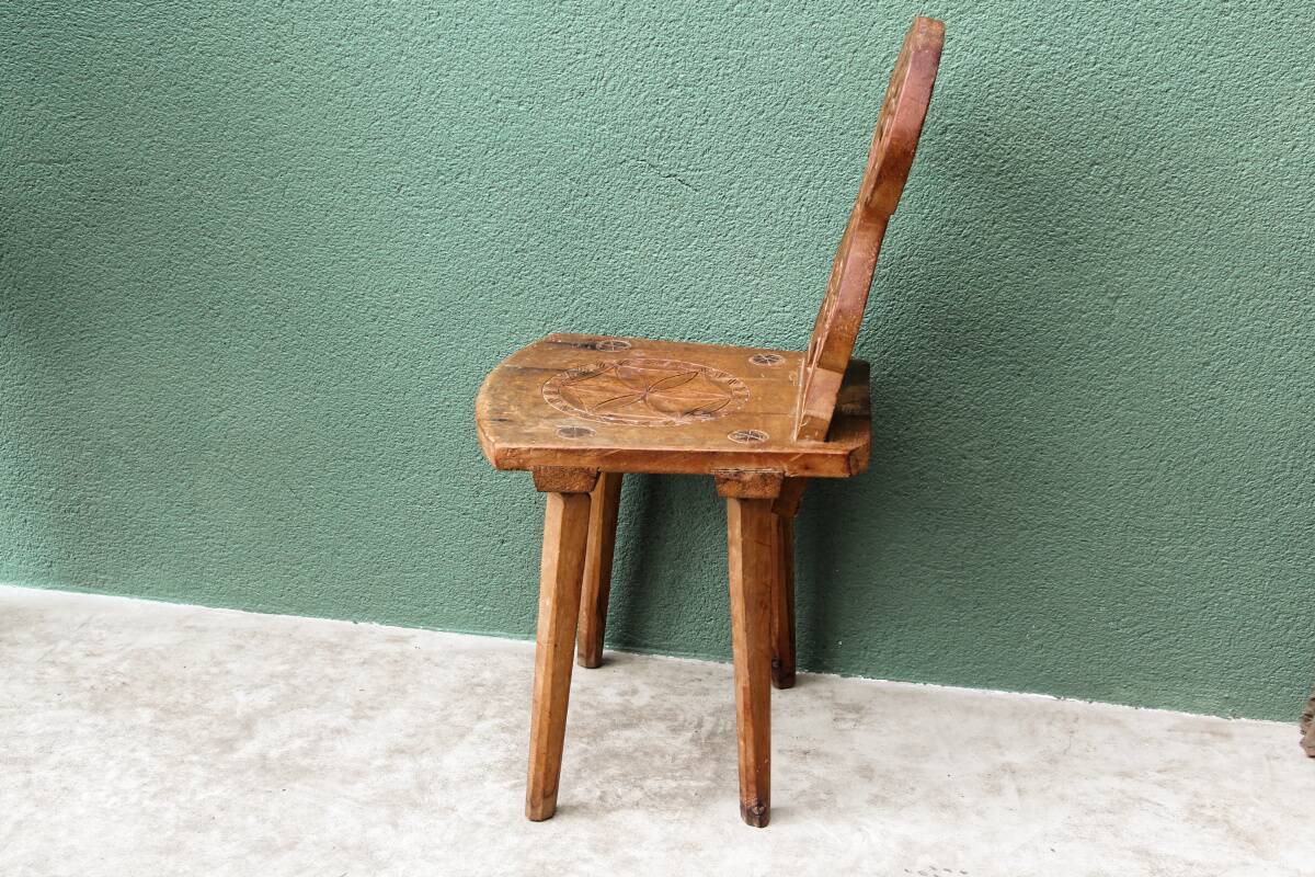 Old Swiss escabelle chair in carved wood