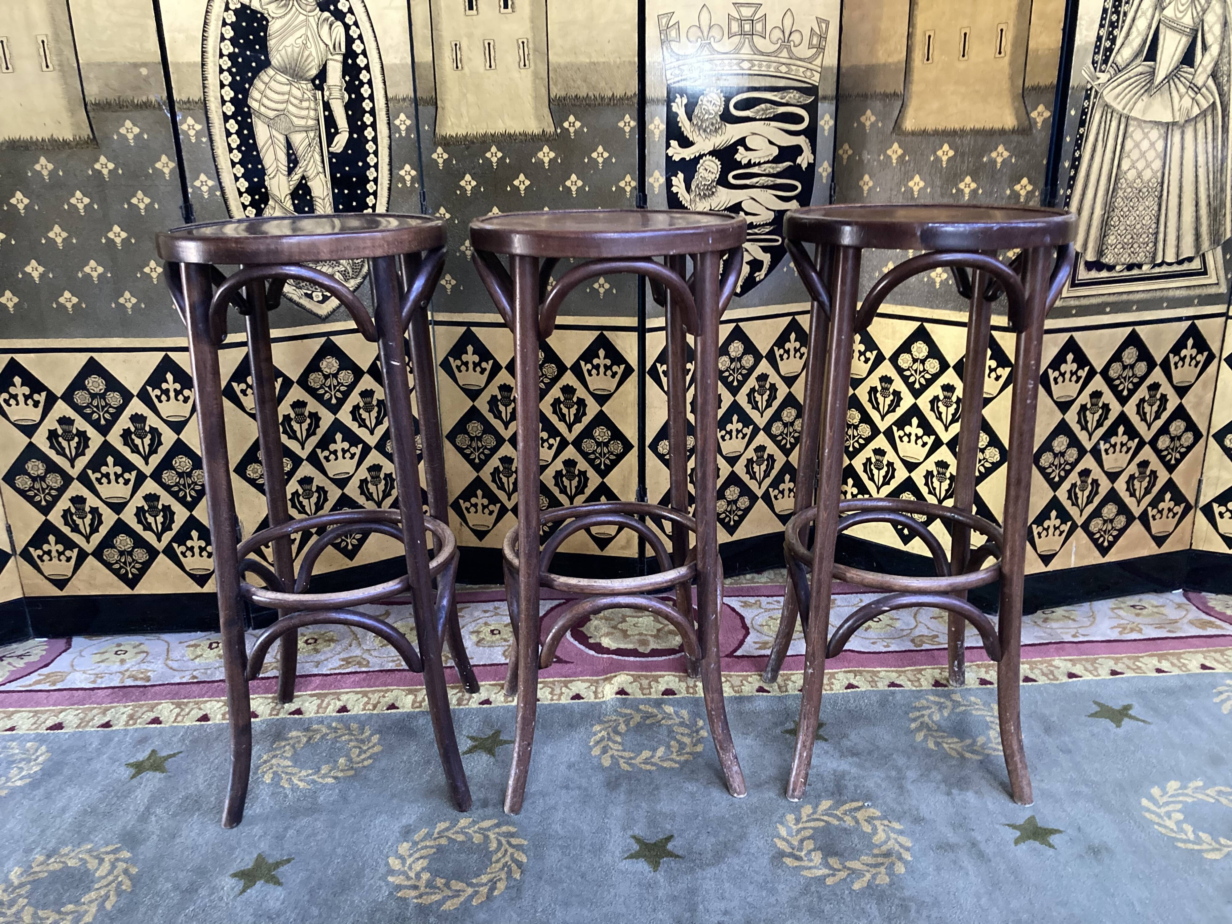 3 curved wooden bar stools