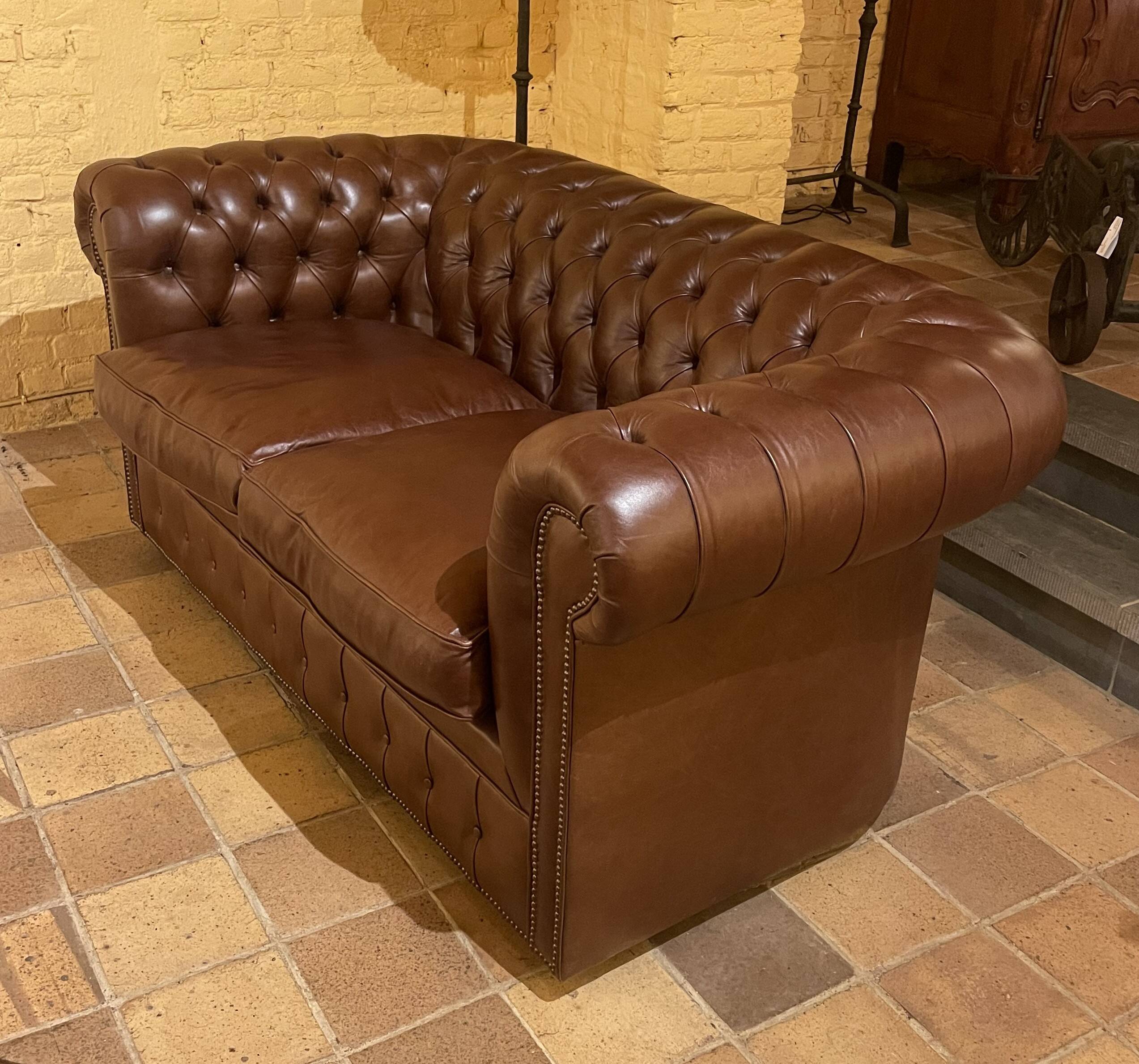 brown leather 2-seater Chesterfield sofa