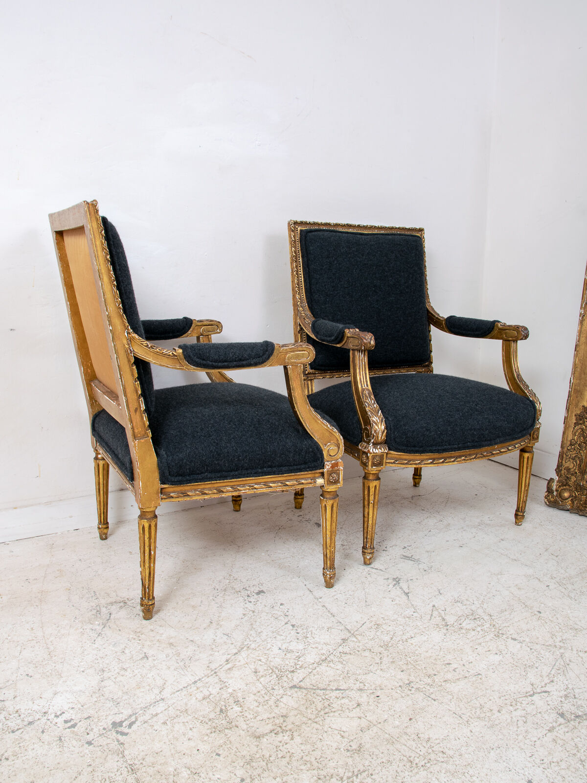 Pair of 19th century Louis XVI gilt armchairs newly re upholstered in holland and sherry fabric