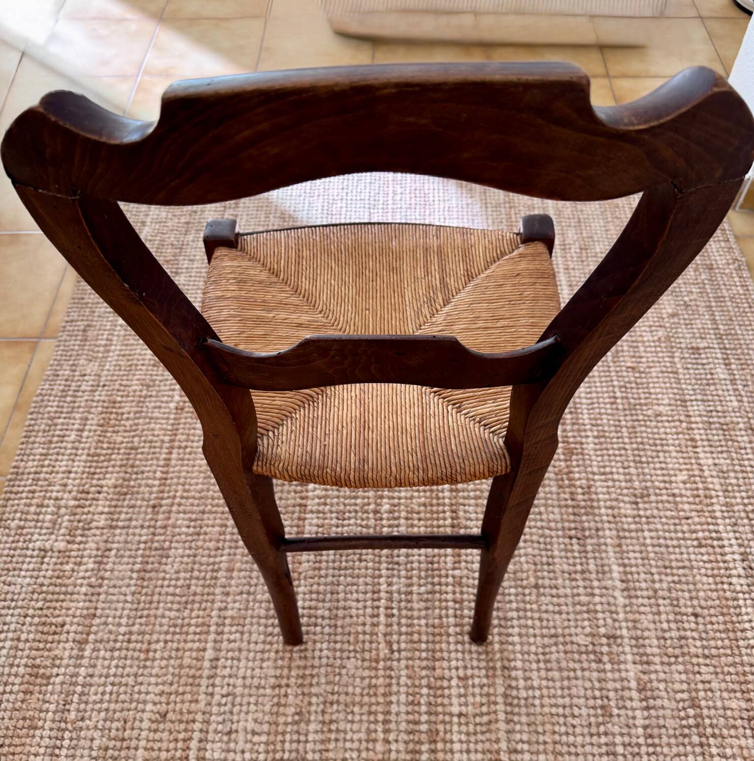 Antique wooden chairs with rush seating.