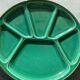 Many glazed stoneware plates with compartments.