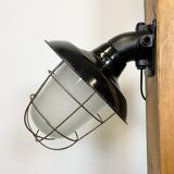 Industrial black enamel and cast iron wall lamp with iron grid, 1960s
