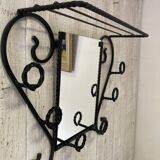 Wall-mounted coat rack with its mirror.