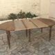 Table ronde 6 pieds 3 rallonges en noyer massif