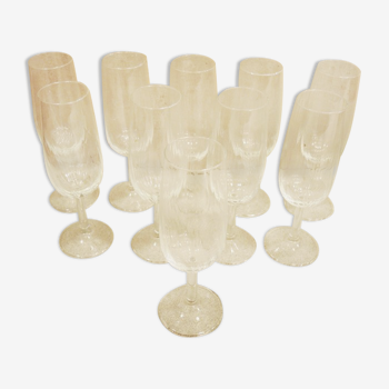 10 old champagne flutes in transparent glass