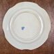 Old Gien plate with carved edges featuring doves and blue flowers, circa 1920-1930.