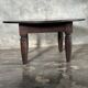 Antique round coffee table in Indonesian teak with turned legs.