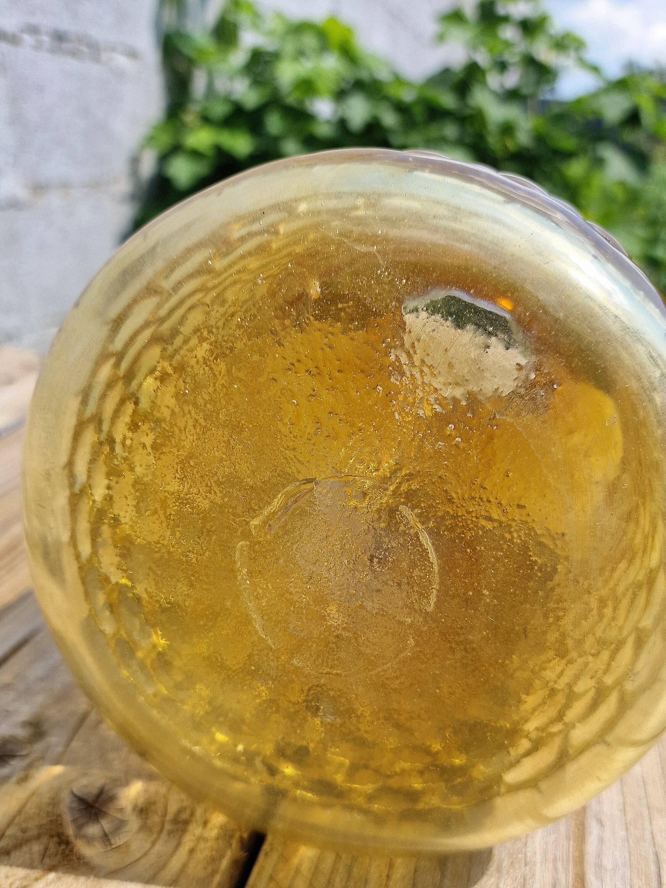 Artisanal blown amber glass vase with integrated honeycomb structure.