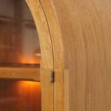 Elegant vintage Danish display cabinet with glass panels and atmospheric lighting