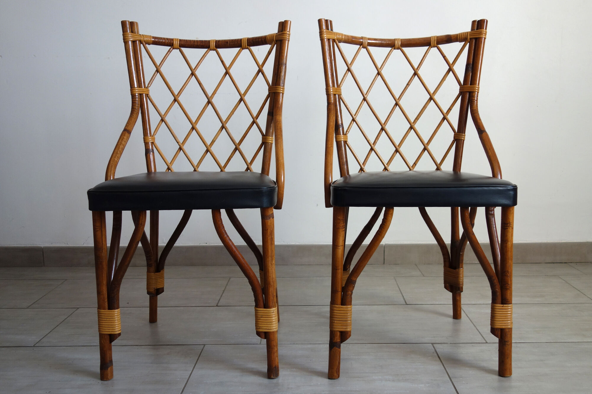 Pair of rattan and black skai bamboo chairs, 60s