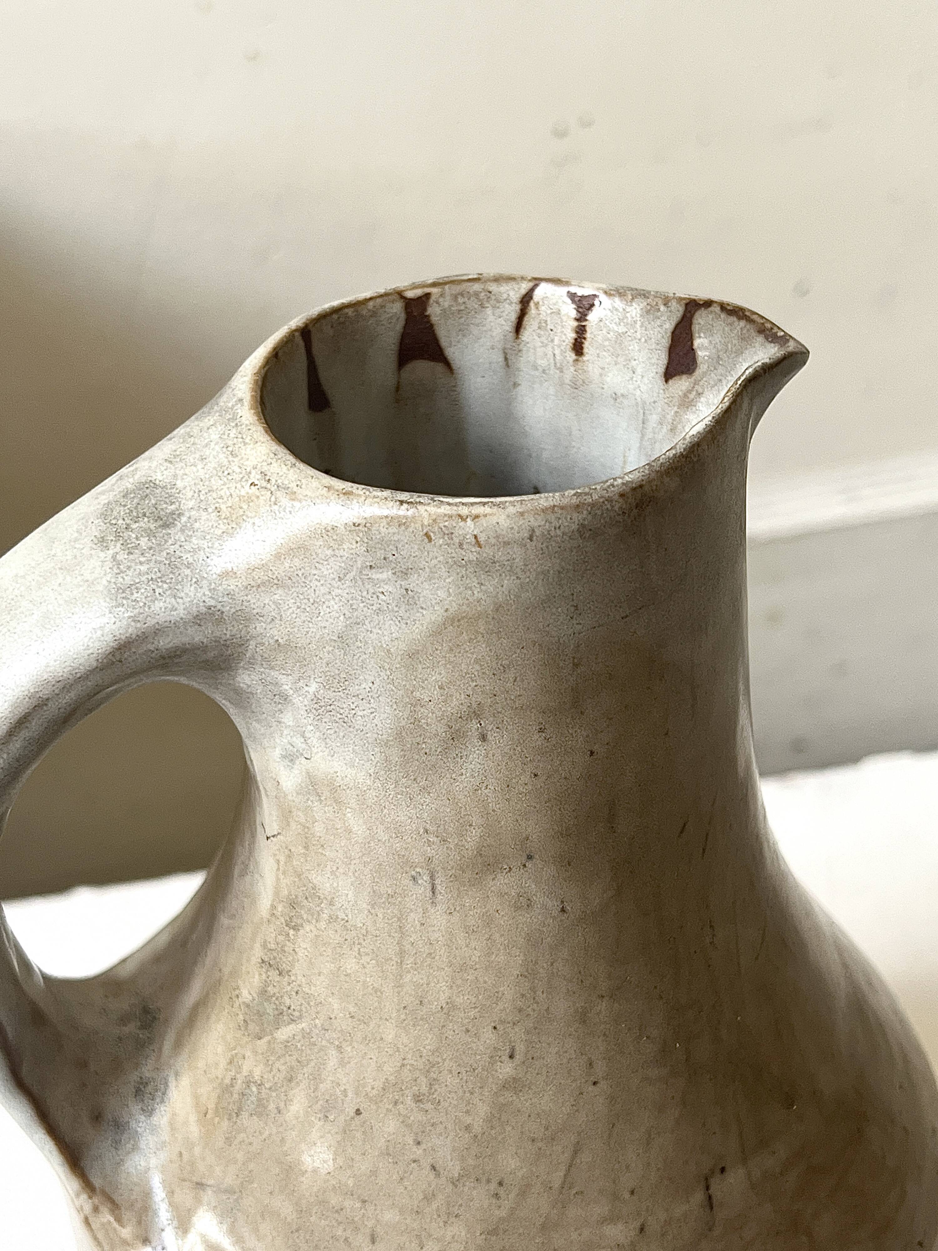 Large brutalist ceramic enamelled jug, signed "MH".