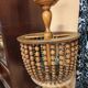 Vintage wooden turned cage chandelier with beads from the 1960s.