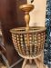 Vintage wooden turned cage chandelier with beads from the 1960s.
