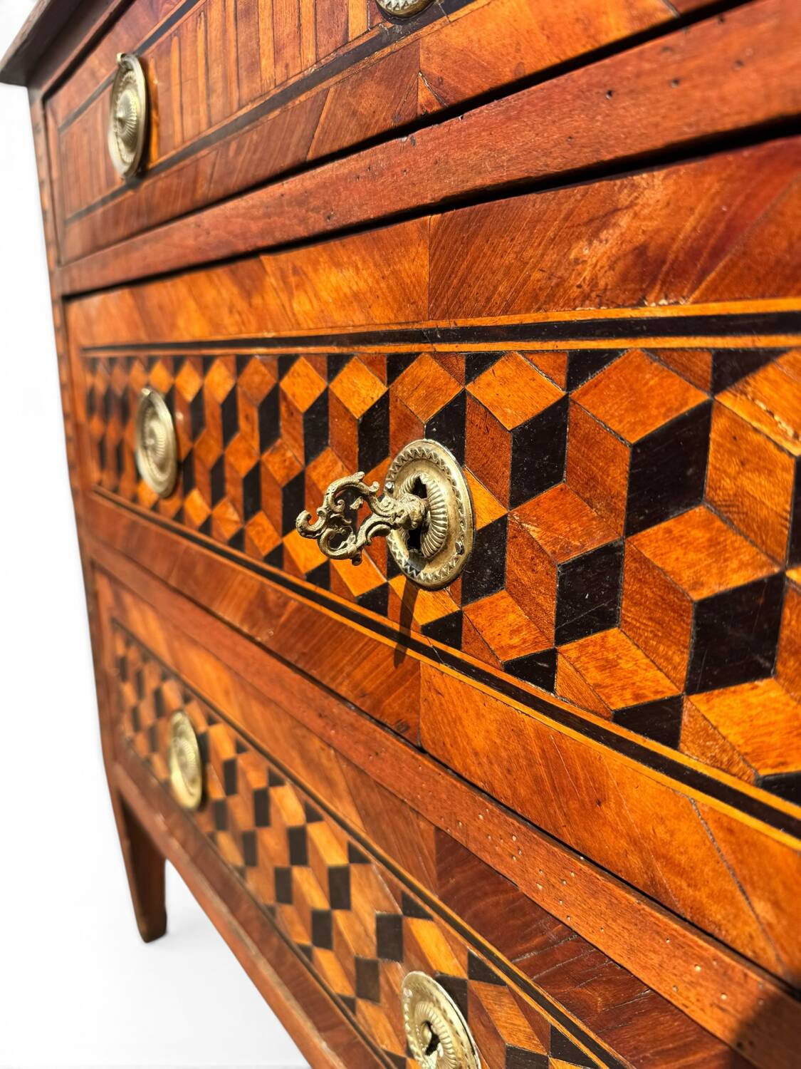 Louis XVI commode with marquetry featuring a design of precious wood cubes, 18th century.