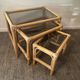 Trio of vintage pull-out tables in rattan and smoked glass 70s