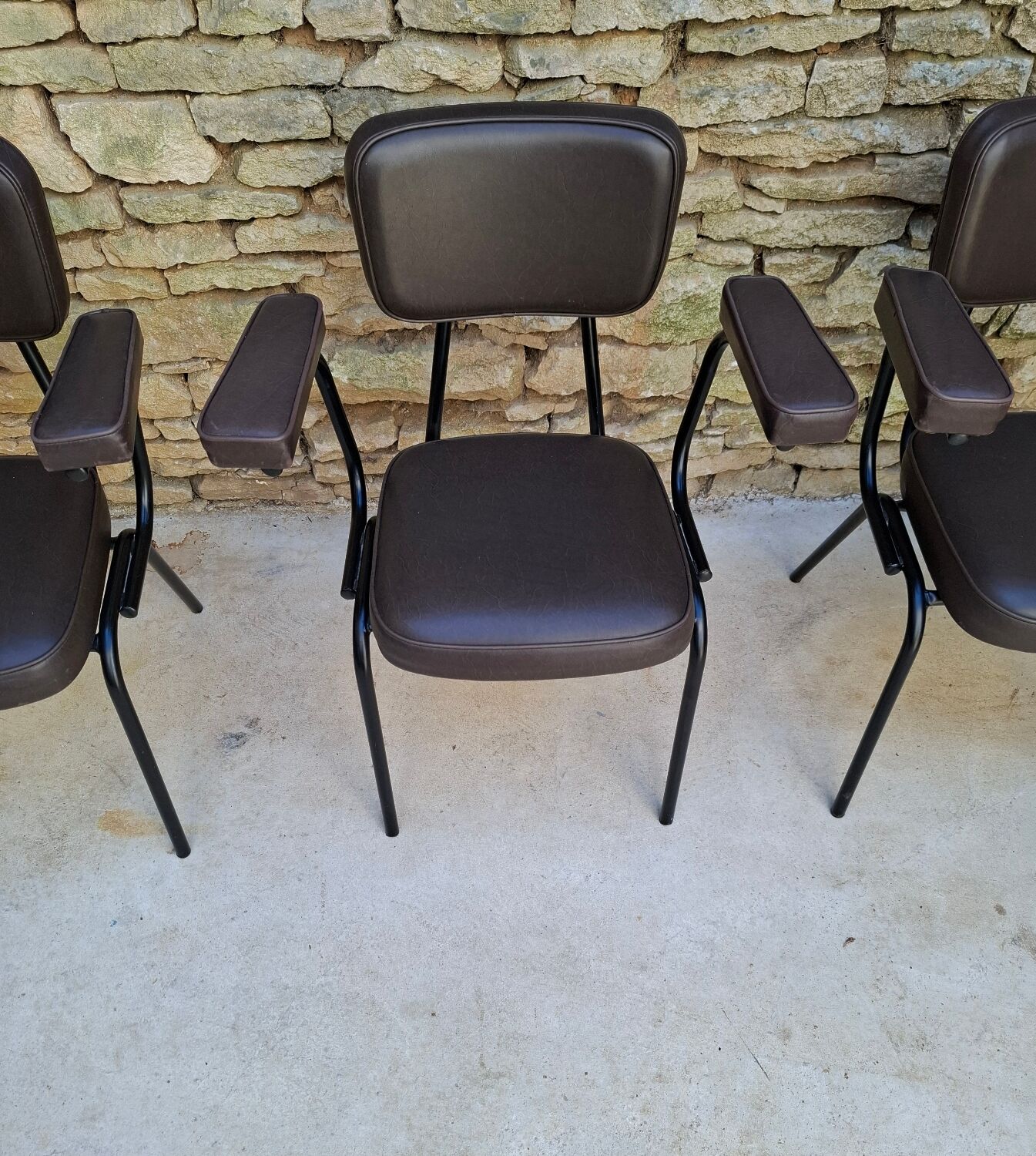 Brown faux leather armchairs