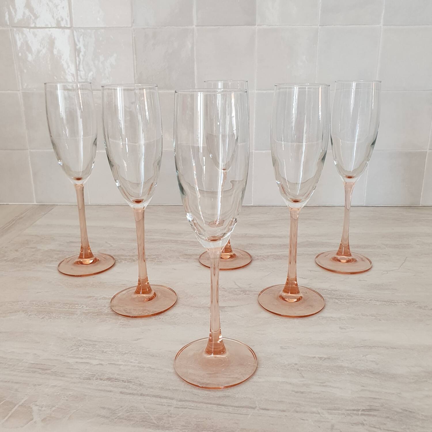 6 champagne flutes with pink stems