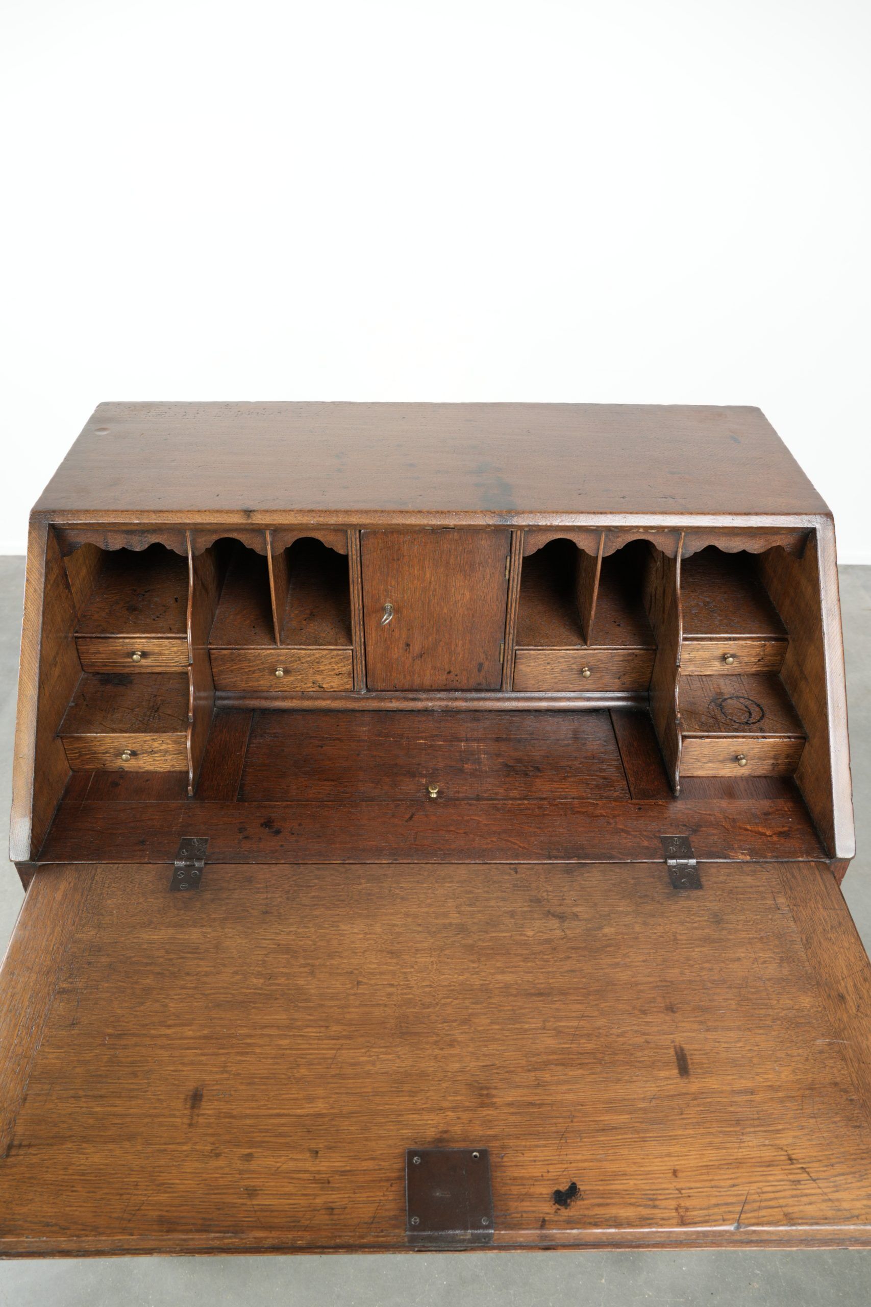 Antique English oak secretary from the 18th century with a stepped interior