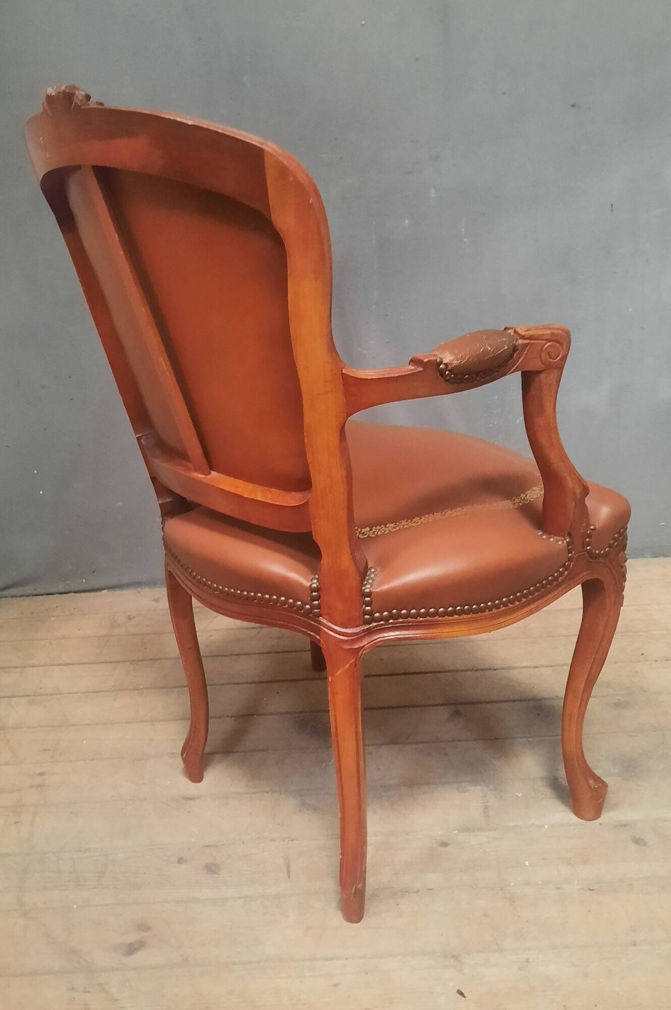 Louis XV style armchair covered in leather.