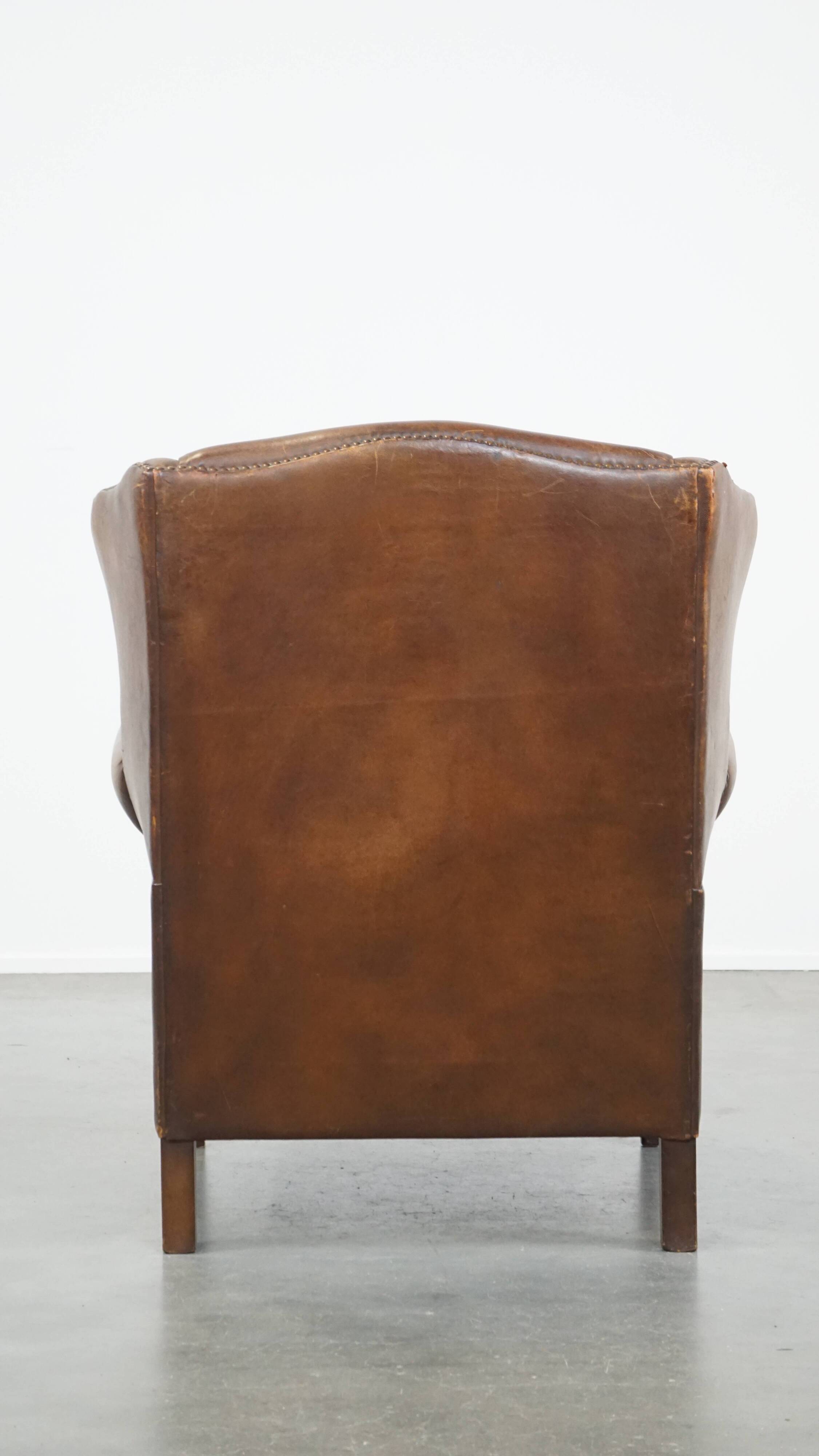 Cognac-colored sheepskin wing chair in English style