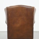 Cognac-colored sheepskin wing chair in English style