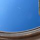 Vintage round smoked plastic mirror, circa 1970s.