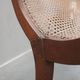 Fauteuil avec assise en cannage et accoudoirs pivotants