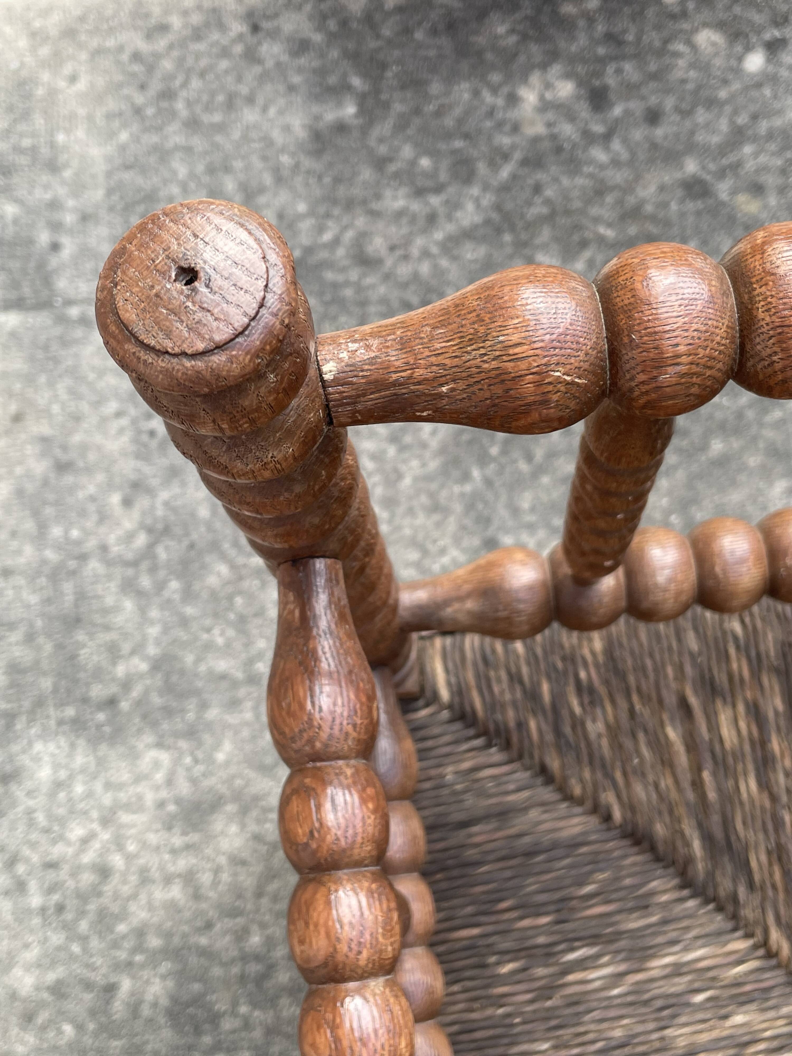 Antique Bobbin armchair with straw seat