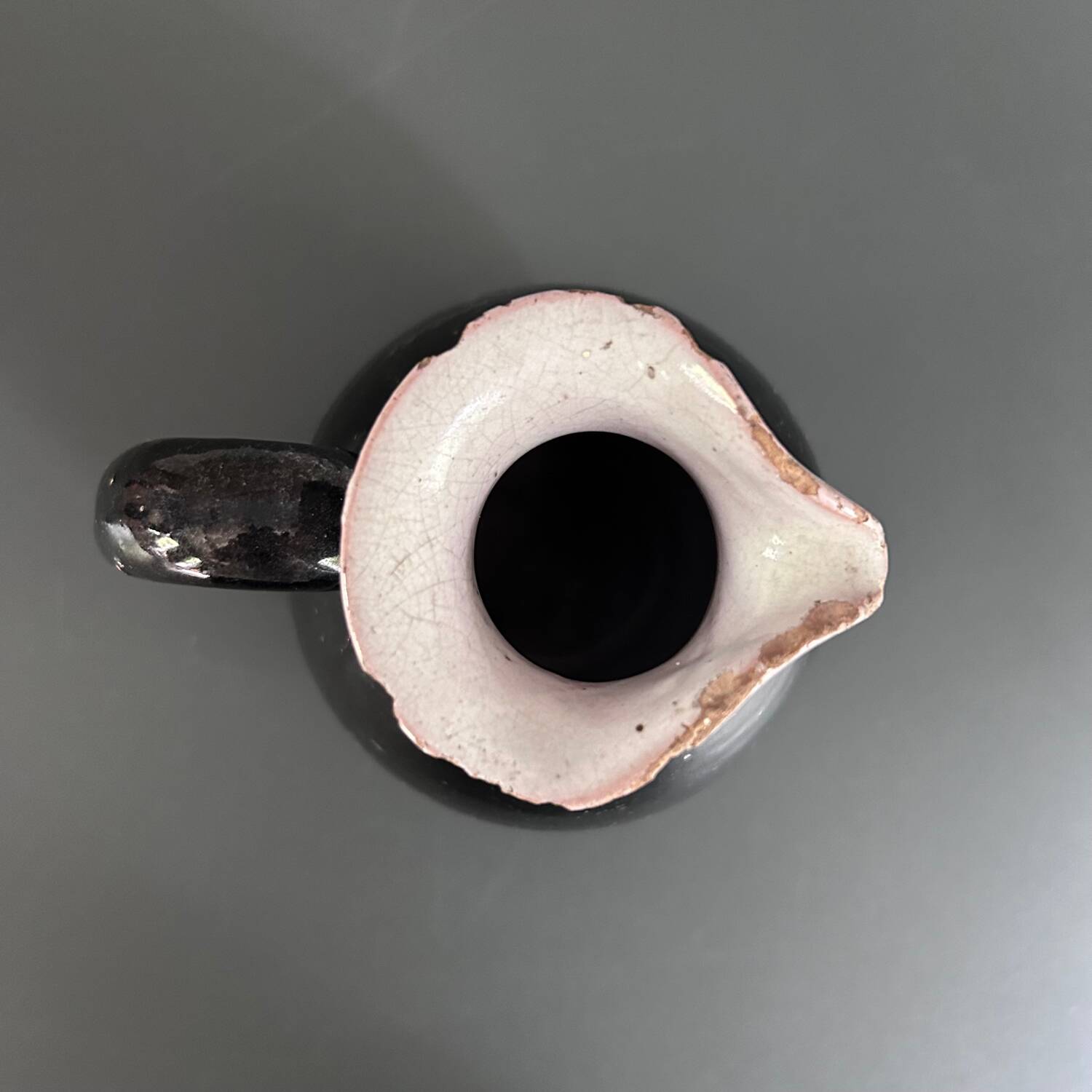 Antique black pitcher with white collar