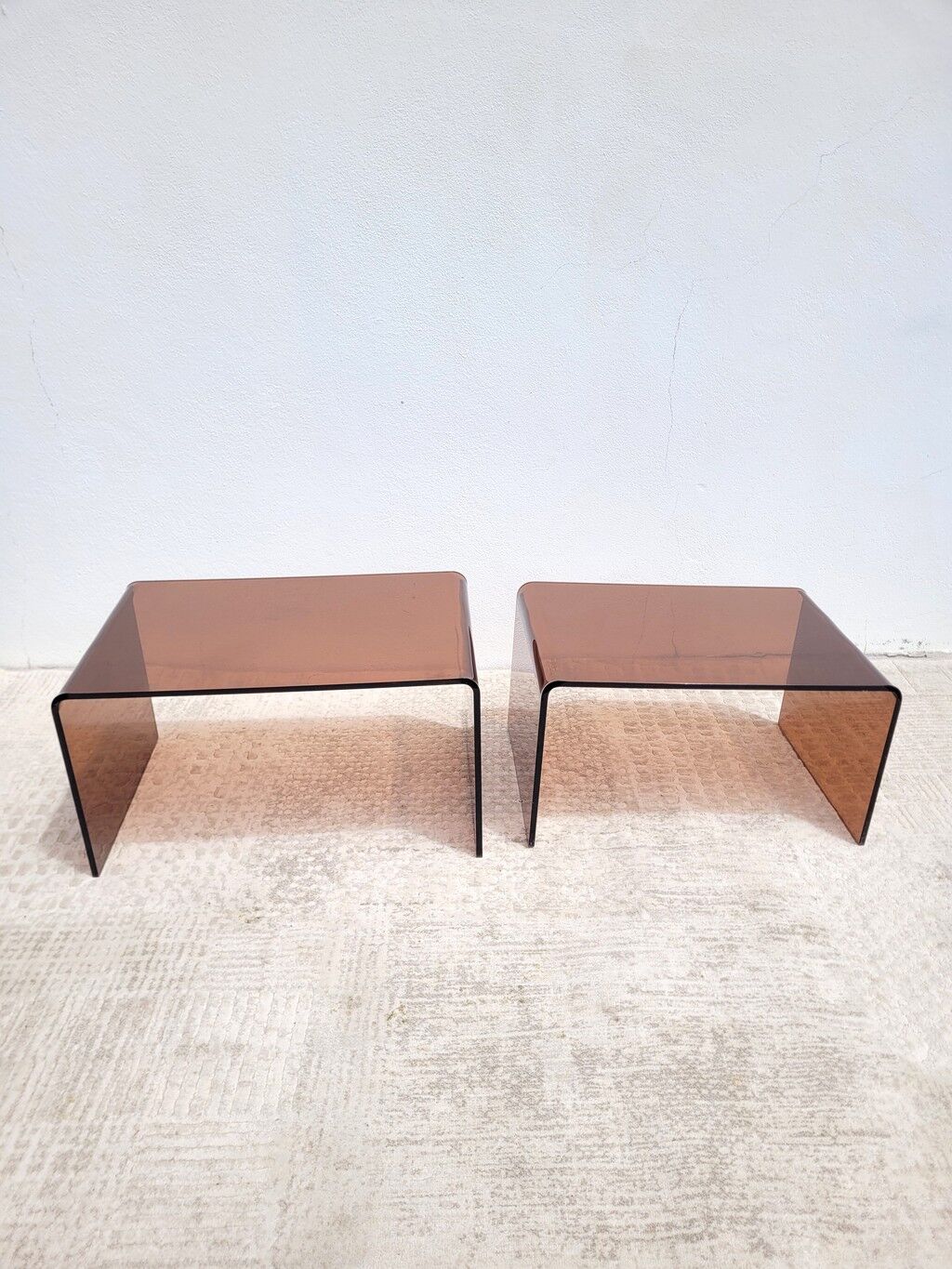 Pair of vintage smoked plexiglass nesting tables.