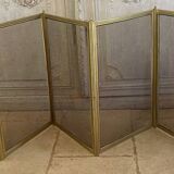 Five-panel golden metal fireplace screen from the 19th century.