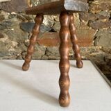 Low tripod stool with turned legs