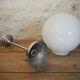 Art Deco suspension globe in white opaline with an aluminium stem.