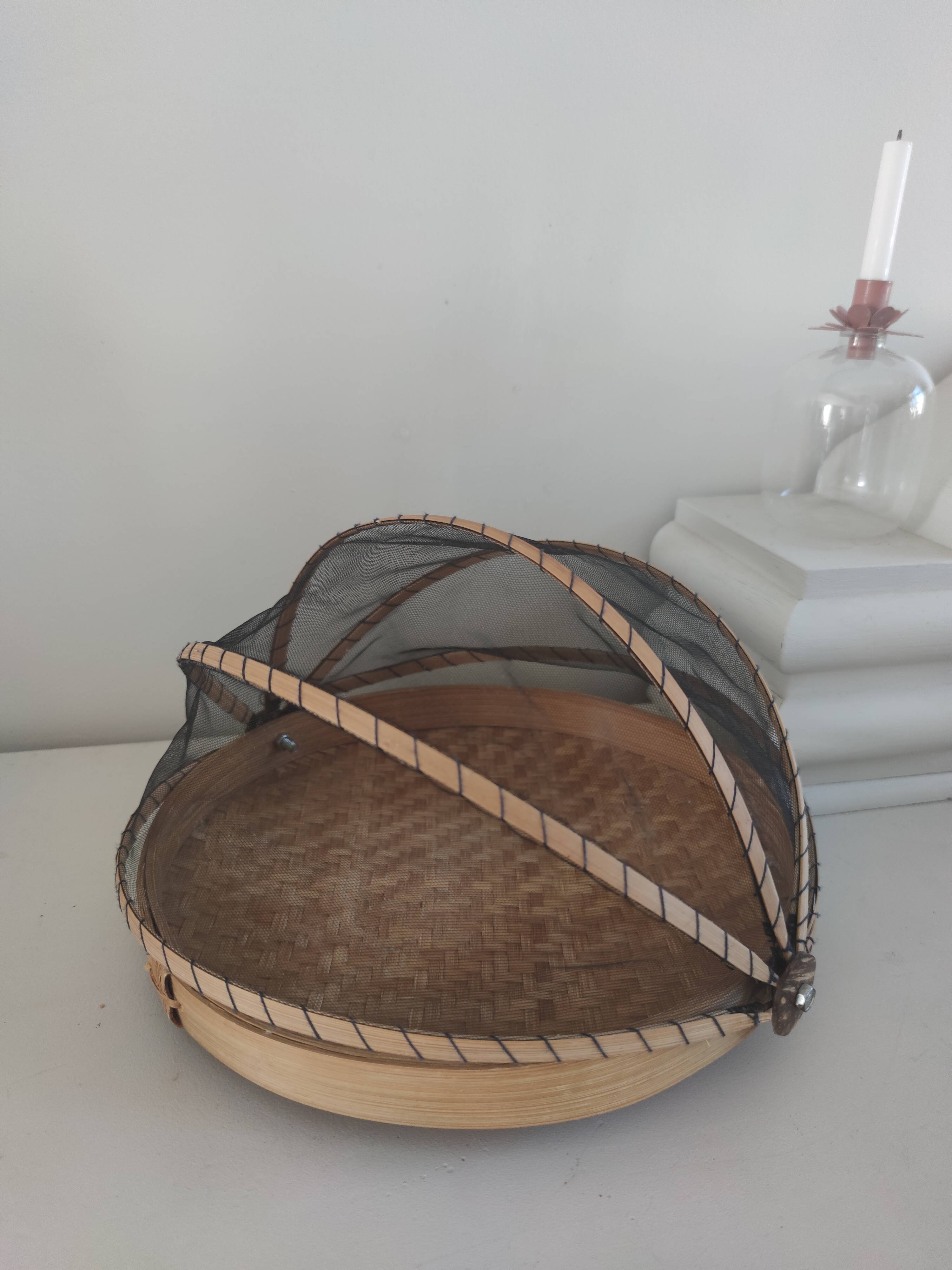 Braided basket with protective mosquito net