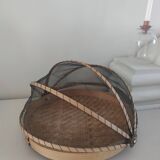Braided basket with protective mosquito net