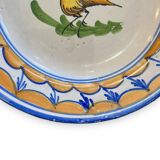Earthenware plate representing a bird signed Lario