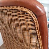 Armchair in woven rattan and exotic wood