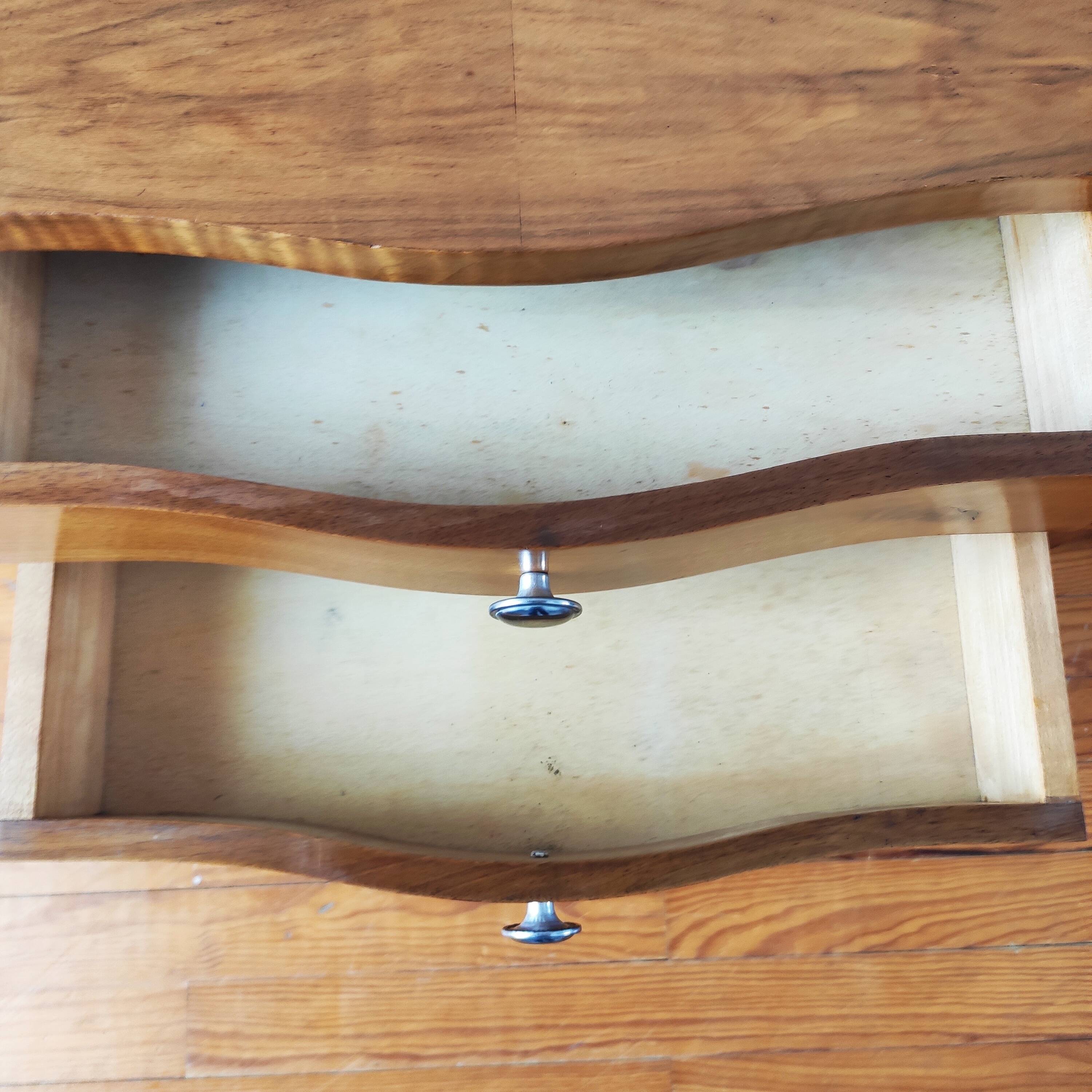 Pair of Art Deco curved bedside tables in light wood.
