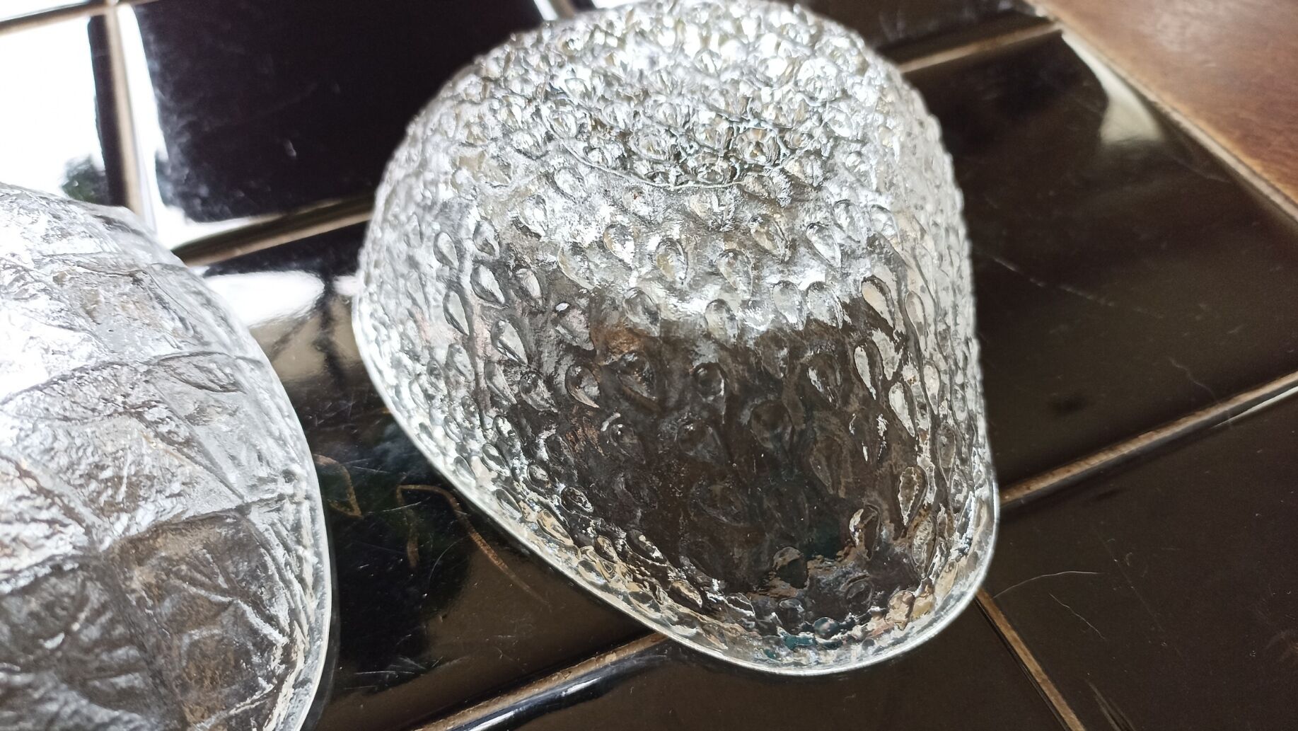 Two molded glass cups in the shape of strawberry and pineapple