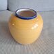 Vintage ceramic vase in a round shape.