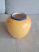 Vintage ceramic vase in a round shape.
