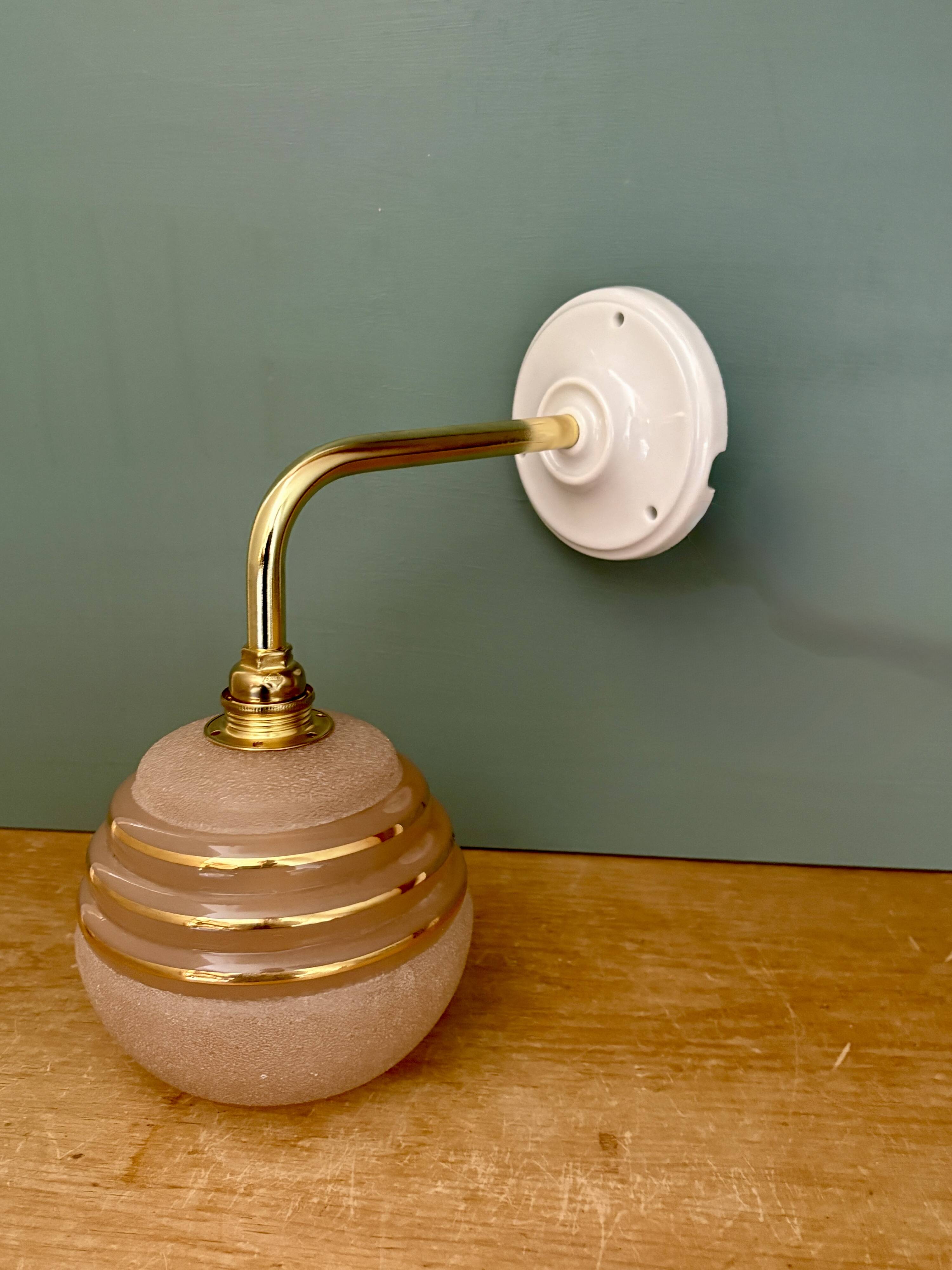 Vintage pink and gold frosted glass globe wall light.